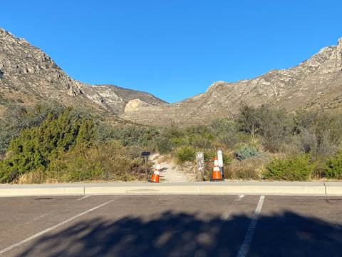 A trail is marked by two orange cones