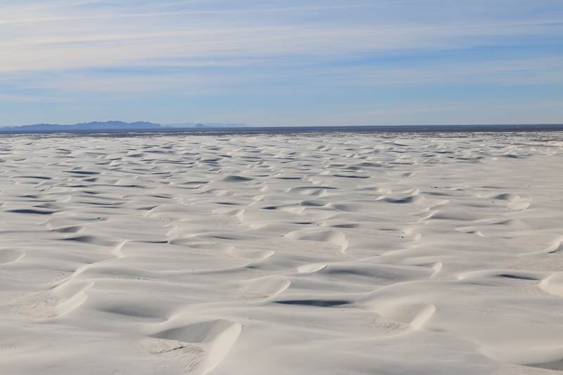 Aerial of white sand dunes.